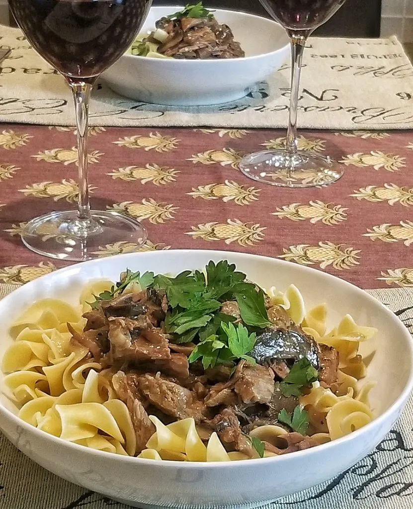 Dairy Free Slow Cooker Beef Stroganoff Bowl of Stroganoff with a Glass of Wine