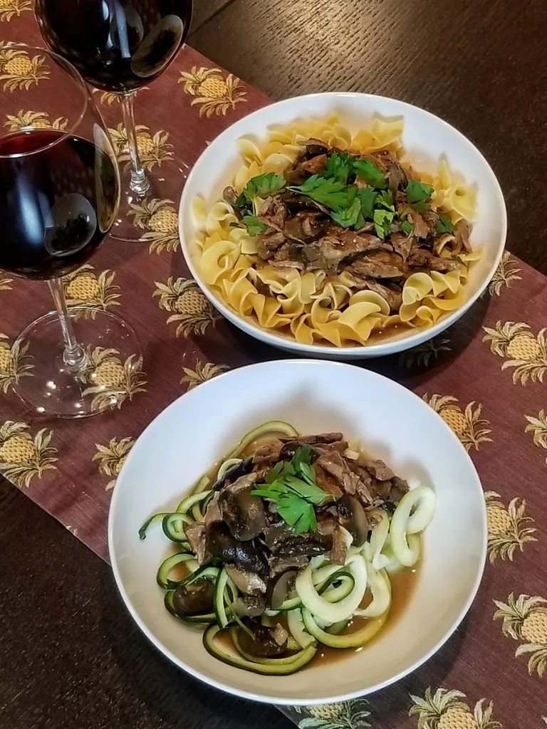 Dairy Free Slow Cooker Beef Stroganoff Overhead View of Stroganoff on a PLate of Zoodles and a Plate of Pasta