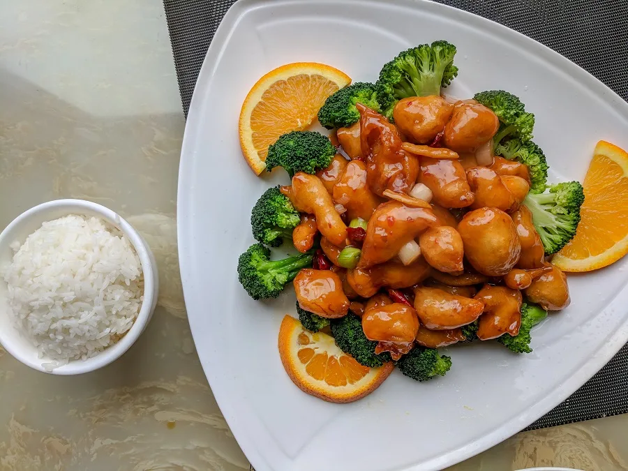 Instant Pot Orange Chicken Recipes Plate of Orange Chicken Next to a Small Bowl of Rice