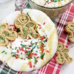 Festive Christmas Latte Recipe a Mug Filled with Latte and Garnished with Whipped Cream, Sprinkles, and Gingerbread Cookies