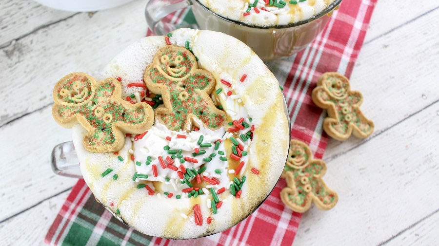 Festive Christmas Latte Recipe a Mug Filled with Latte and Garnished with Whipped Cream, Sprinkles, and Gingerbread Cookies