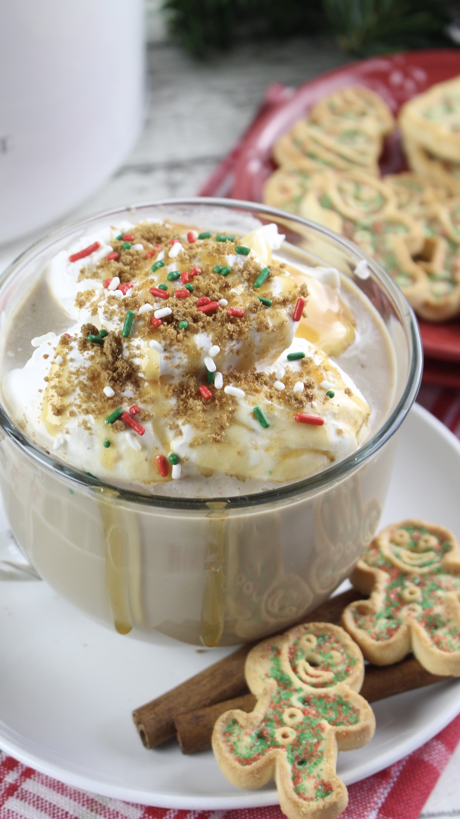 Festive Christmas Latte Recipe a Coffee Mug on a Saucer with Two Gingerbread Cookies and a Cinnamon Stick