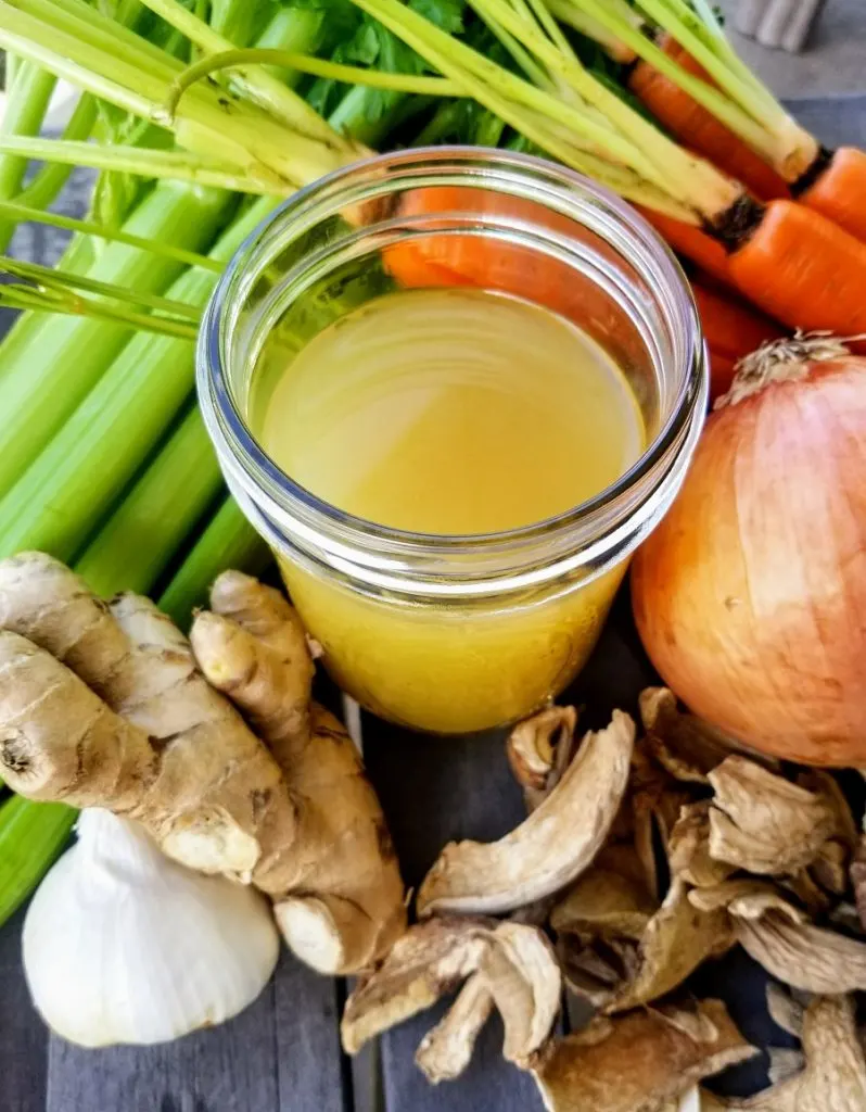 Slow Cooker Chicken Bone Broth Recipe Overhead View of Bone Broth in a Glass Jar