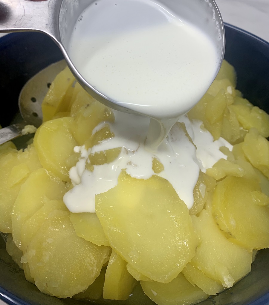 Instant Pot Sour Cream Scalloped Potatoes Cream Poured onto Potato Slices