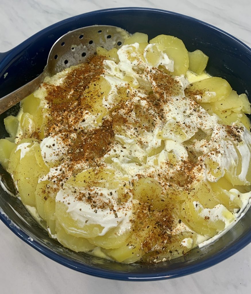 Instant Pot Sour Cream Scalloped Potatoes Seasoning Added to Potatoes
