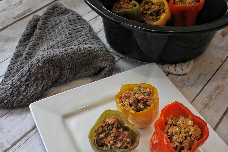 Low Carb Slow Cooker Stuffed Peppers On a Plate Next to Crockpot
