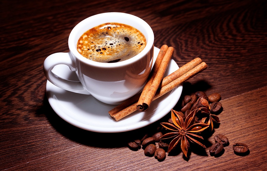 Slow Cooker Holiday Latte Recipes Overhead View of a Cup of Coffee with Raw Cinnamon and Nutmeg