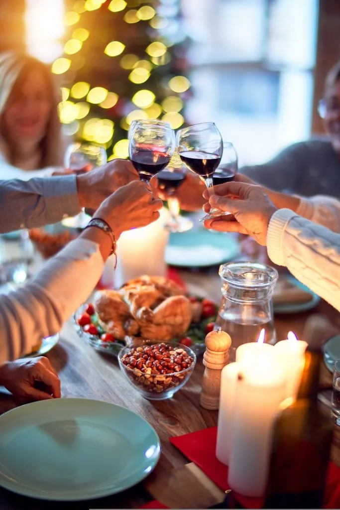 Instant Pot Holiday Side Dishes People Clinking Wine Glasses Together Above a Holiday Table