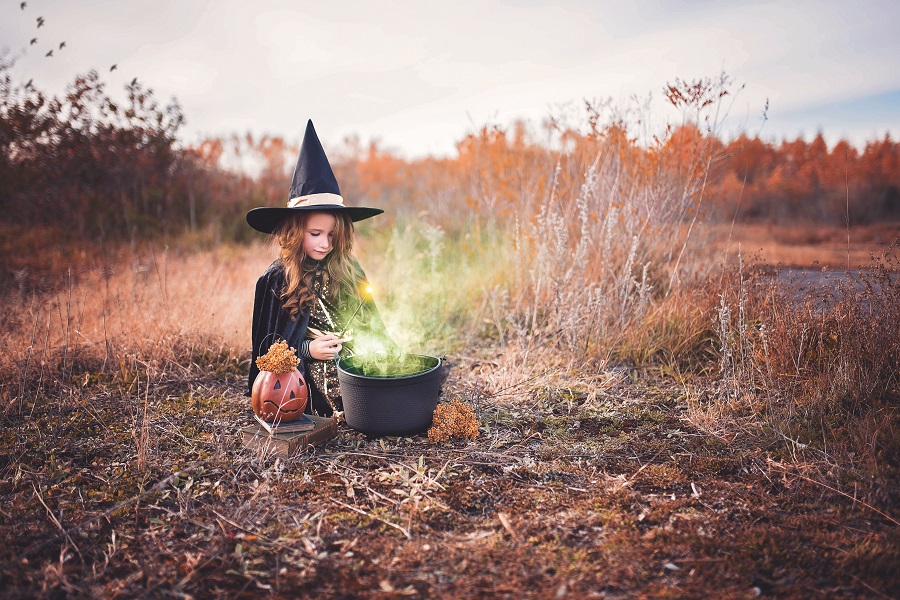 Crockpot Halloween Recipes Little Girl Dressed as a Witch Making a Brew in a Field