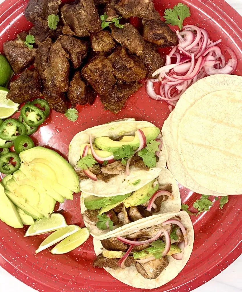 Crockpot Pulled Pork Tacos Recipe Overhead View of Pork Tacos on a Red Plate