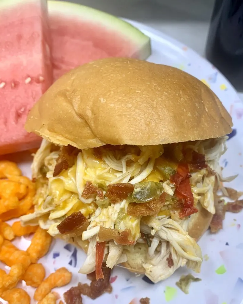Crockpot Shredded Chicken Sandwiches Sandwich on a Plate with Watermelon Slices