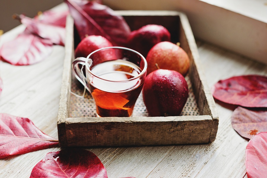 Halloween Slow Cooker Cider Apples on a Serving Tray with Cider