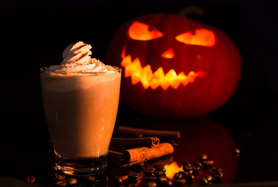 Halloween Slow Cooker Cider a Cup of Hot Chocolate in Front of a Pumpkin