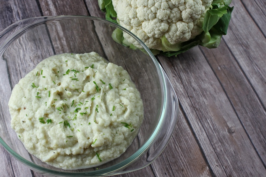 Instant Pot Cauliflower Mash Recipe a Glass Bowl of Mashed Cauliflower Next to a Head of Cauliflower