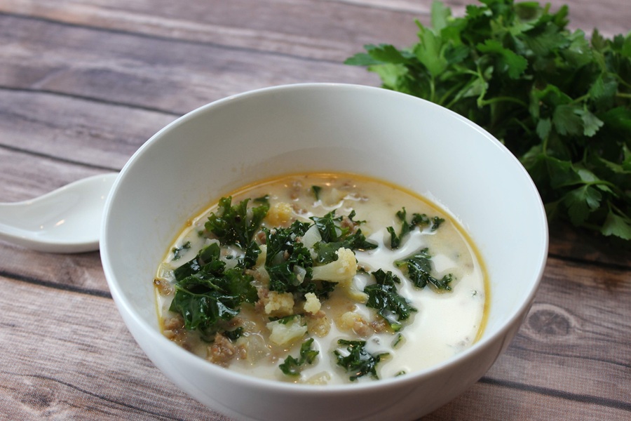 Easy Creamy Kale Soup a Bowl of Kale Soup on a Wooden Surface