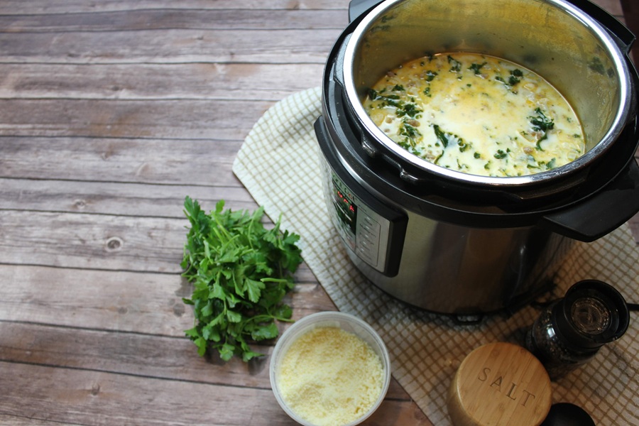 Easy Creamy Kale Soup an Instant Pot Filled with Kale Soup Next to Parsley and Parmesan Cheese