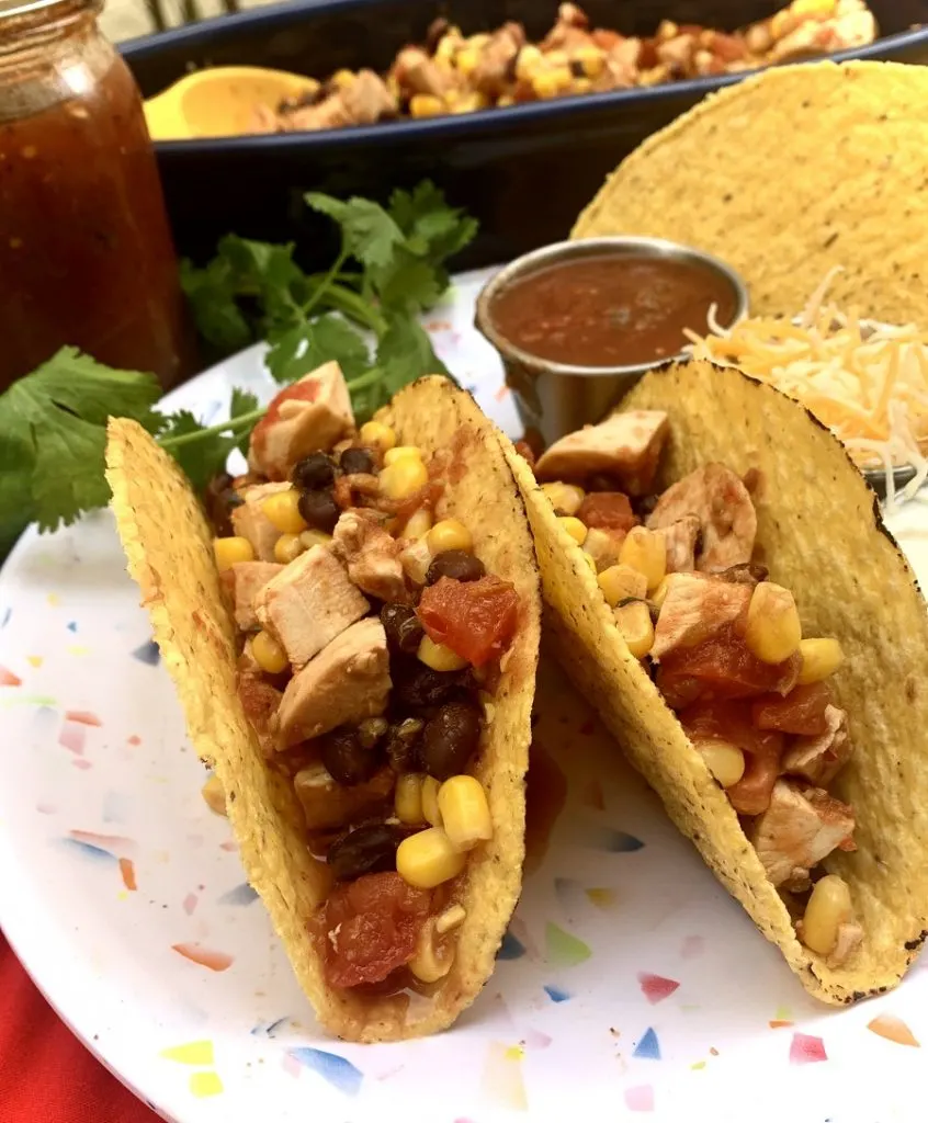 Easy Slow Cooker Salsa Chicken for Tacos a Couple of Tacos on a White Plate