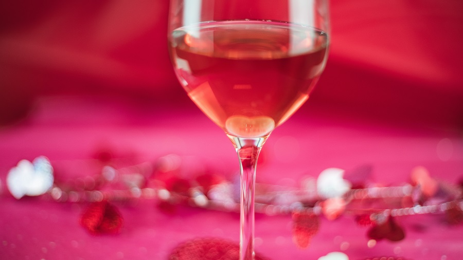 Instant Pot Valentine's Day Recipes a Glass of Wine with Roses in the Background