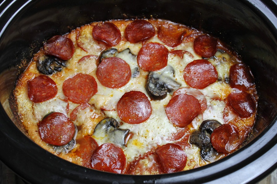 Crock Pot Pizza Casserole Close Up of a Crock Pot Filled with Pizza Casserole Topped with Pepperoni and Mushrooms