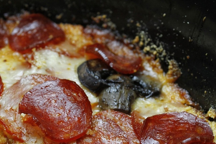 Crock Pot Pizza Casserole Close Up of Pepperoni and Mushrooms On Top of a Casserole in a Crock Pot