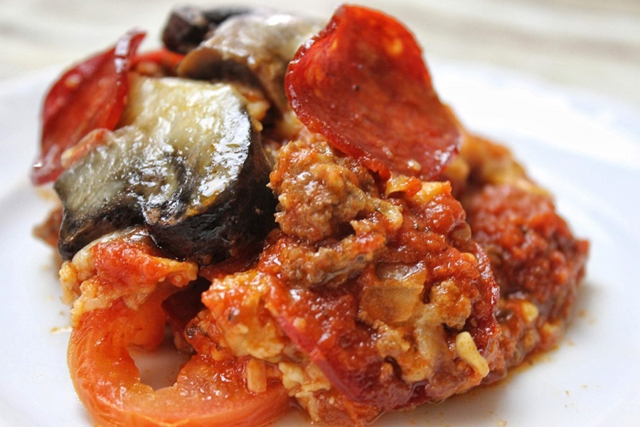 Crock Pot Pizza Casserole on a White Plate Topped with Mushrooms and Pepperoni