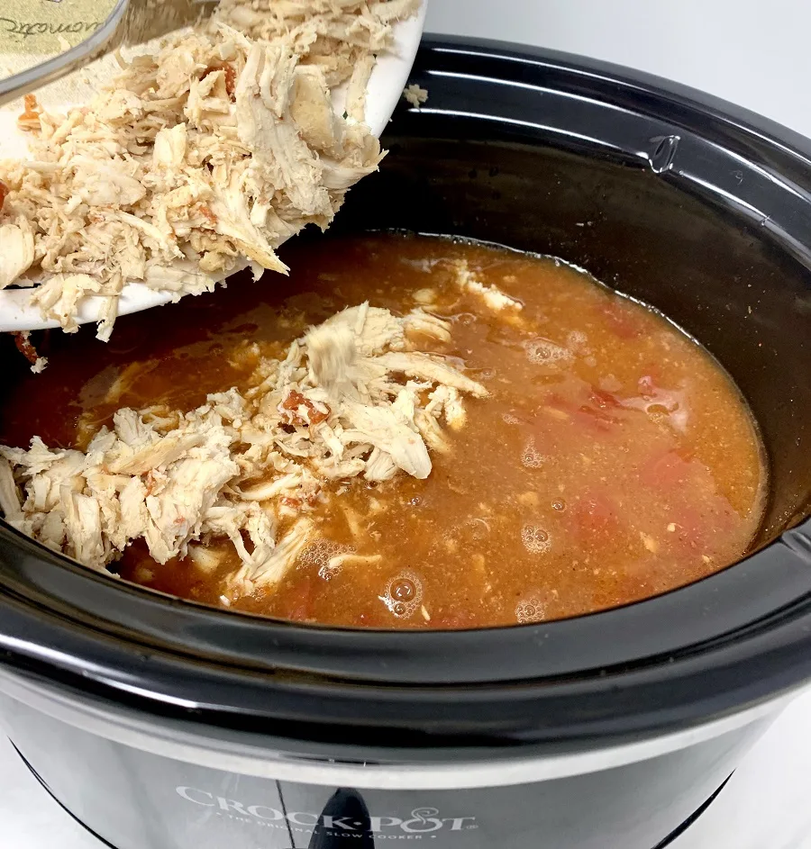 Crockpot Chicken and Rice Burrito Bowl Recipe Person Pouring Chicken into a Crockpot
