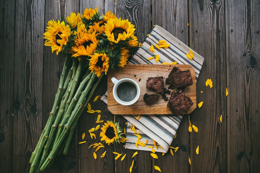 Instant Pot Brownie Desserts Overhead View of Brownies on a Plate with Coffee and Sun Flowers Next to Them