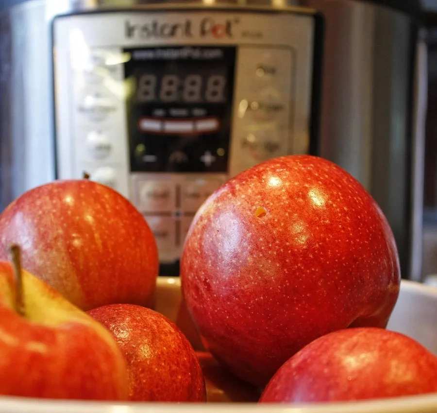 Close Up of Raw Apples in Front of an Instant Pot