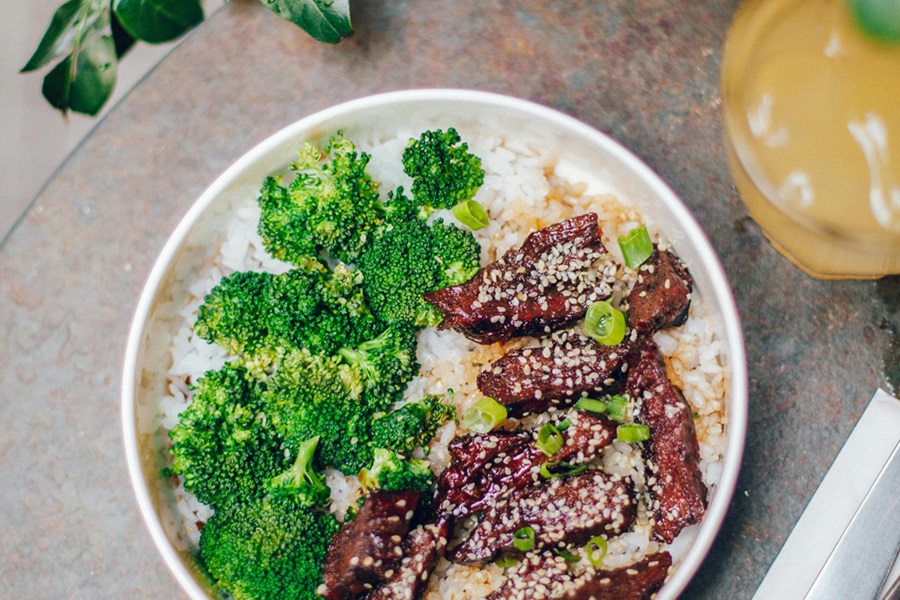Healthy Crockpot Freezer Meals with Beef Close Up of a Bowl of Rice Topped with Broccoli and Beef Garnished with Sesame Seeds