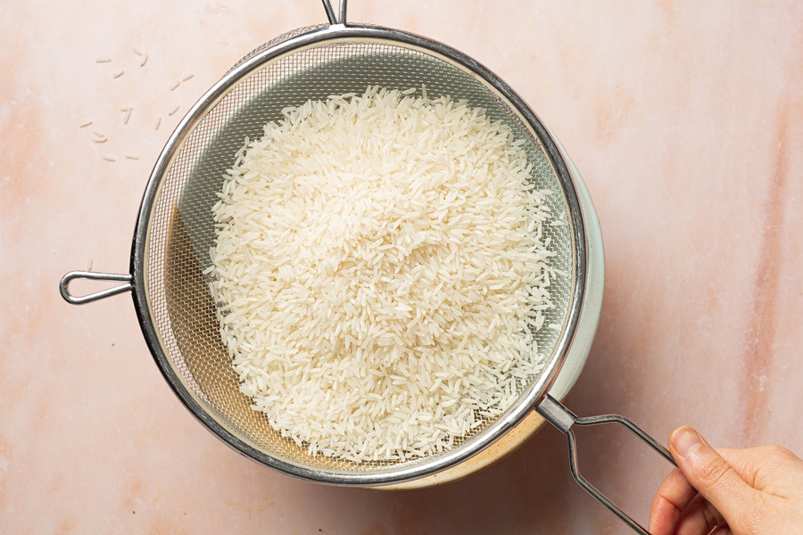 Salsa Chicken and Rice Crock Pot Recipe Rice in a Mesh Strainer Being Rinsed