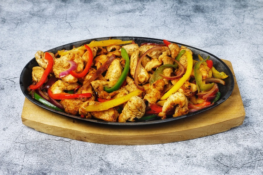 Easy Crockpot Freezer Meals for Meal Planning a Single Skillet Filled with Chicken Fajitas