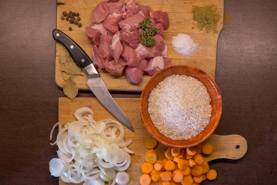 Easy Crockpot Freezer Meals for Meal Planning Two Cutting Boards Topped with Chopped Onions, Carrots, and Beef