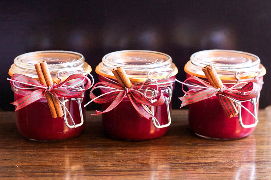 Instant Pot Cranberry Chicken Recipes a Row of Three Jars Filled with Cranberry Sauce on a Wooden Table