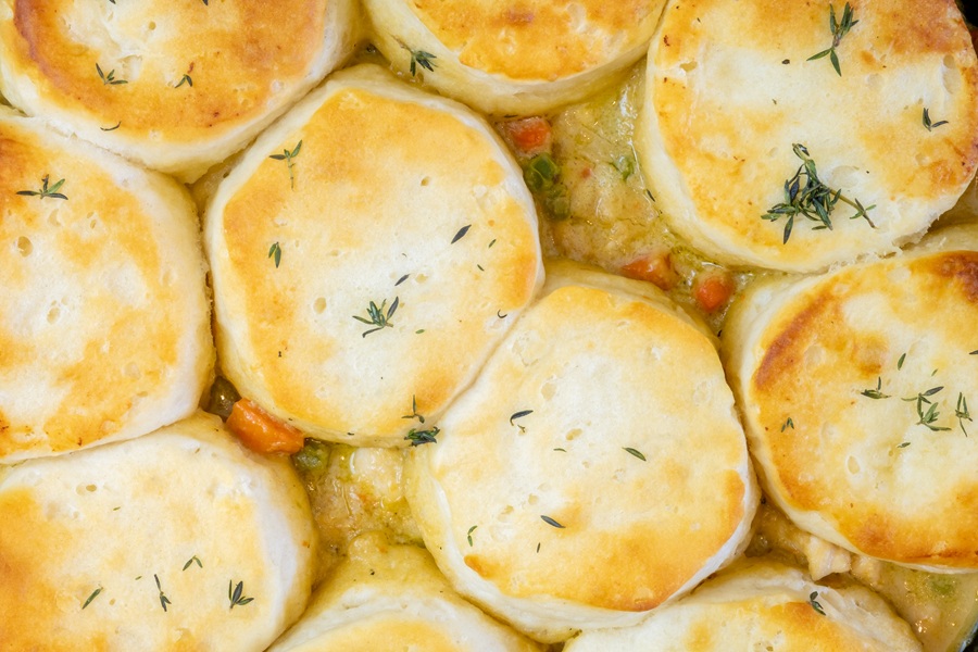 Quick Chicken Pot Pie Casserole Recipes Close up of Chicken Pot Pie with biscuits used on top cooked to a toasty golden brown in a cast iron skillet.