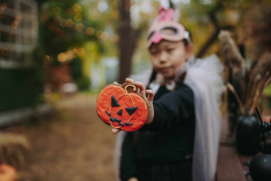 Halloween Deviled Egg Recipes Kid in a Costume Holding Up a Jack-O-Lantern Cookie