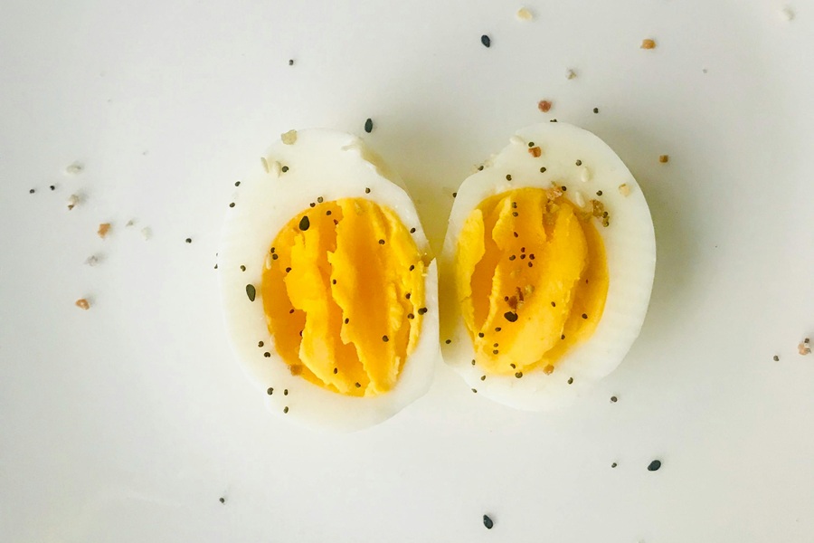 Halloween Deviled Egg Recipes Close Up of a Hard Boiled Egg Cut in Half and Sprinkled with Pepper