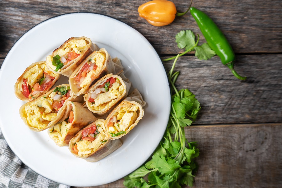 Instant Pot Breakfast Burrito Four Burritos Cut in Half and Standing Side by Side on a Plate