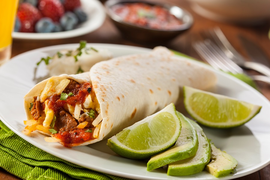 Instant Pot Breakfast Burrito Recipes a Breakfast Burrito on a Plate with Lime Wedges and Sliced Avocado