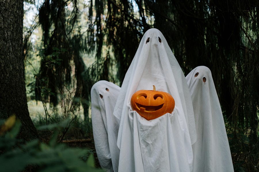 Instant Pot Halloween Recipes Three People Standing Together Each Dressed as a Ghost and One Holding a Pumpkin