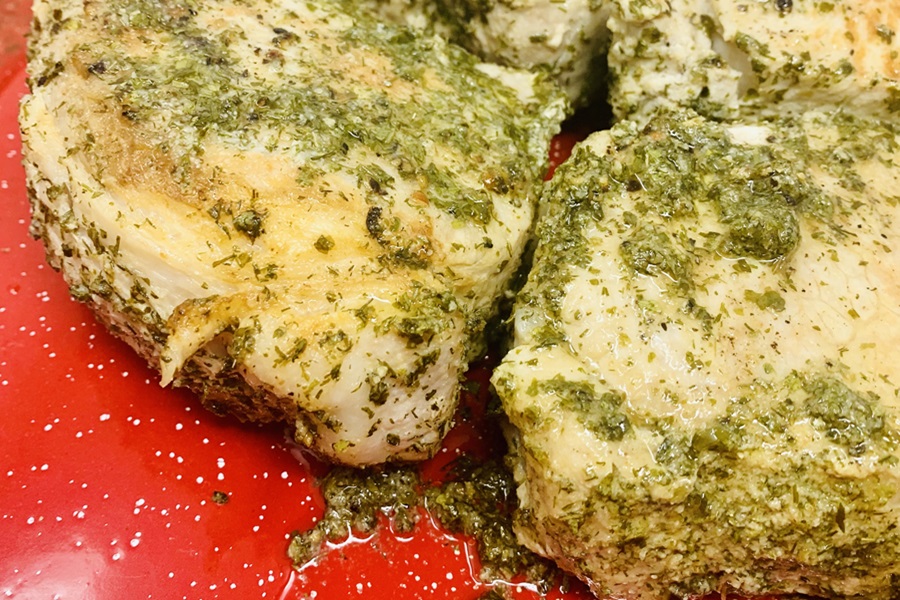 Instant Pot Frozen Pork Chops Close Up of Two cooked Pork Chops on a Red Plate