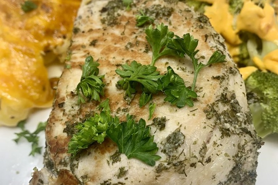 Instant Pot Frozen Pork Chops Close Up of a Single Pork Chop with Parsley On Top