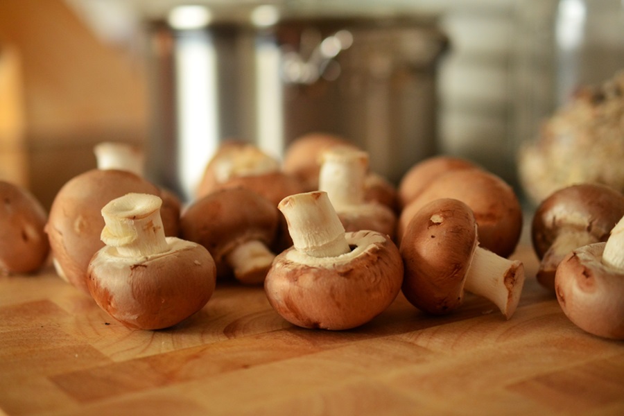 Healthy Crockpot Breakfast Casserole Recipe Close Up of Mushrooms on a Wooden Cutting Board