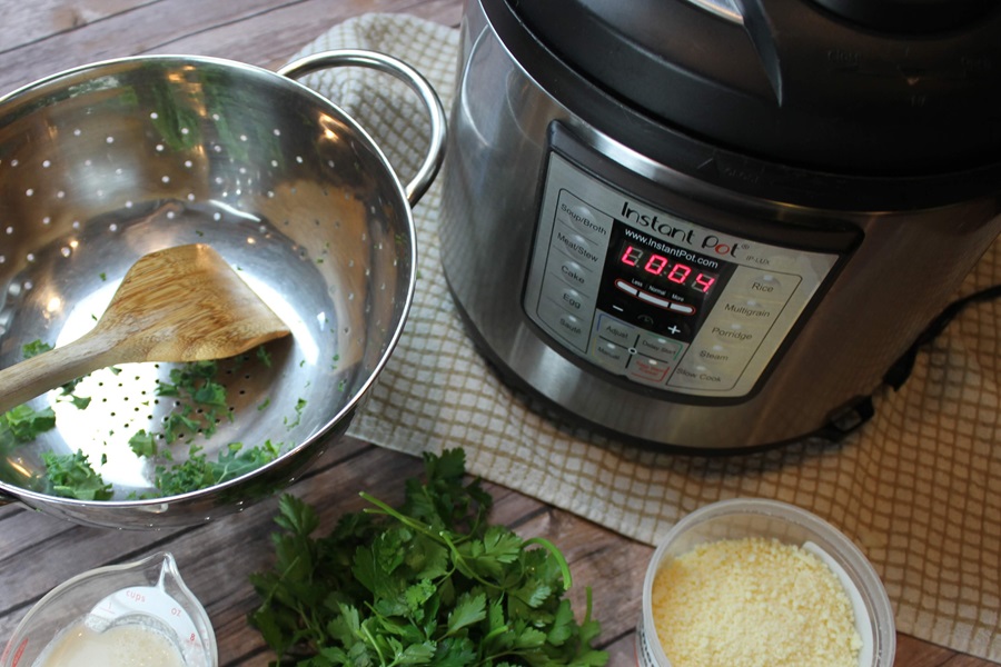Instant Pot Cooking Tips and Tricks An Instant Pot Next to a Strainer, a Small Dish of Parmesan Cheese, Kale, and Salt on a Counter Top