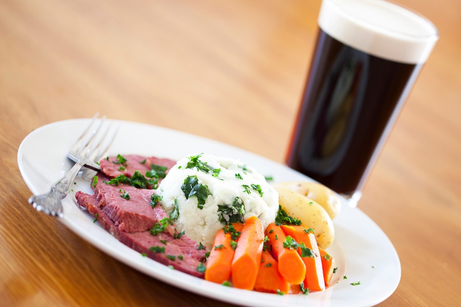 Crockpot Corned Beef and Cabbage Recipes Angled View of a Plate of Corned Beef and Cabbage with a Glass of Beer