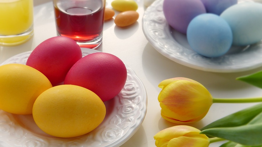  Instant Pot Easter Egg Recipes Close Up of Pastel Colored Easter Eggs on White Plates with Flowers