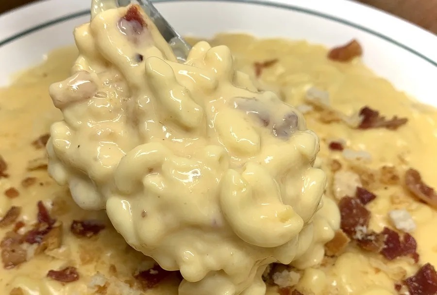 Crockpot Easter Side Dish Recipes Close Up of a Bowl of Macaroni and Cheese with a Spoonful of Pasta and Cheese