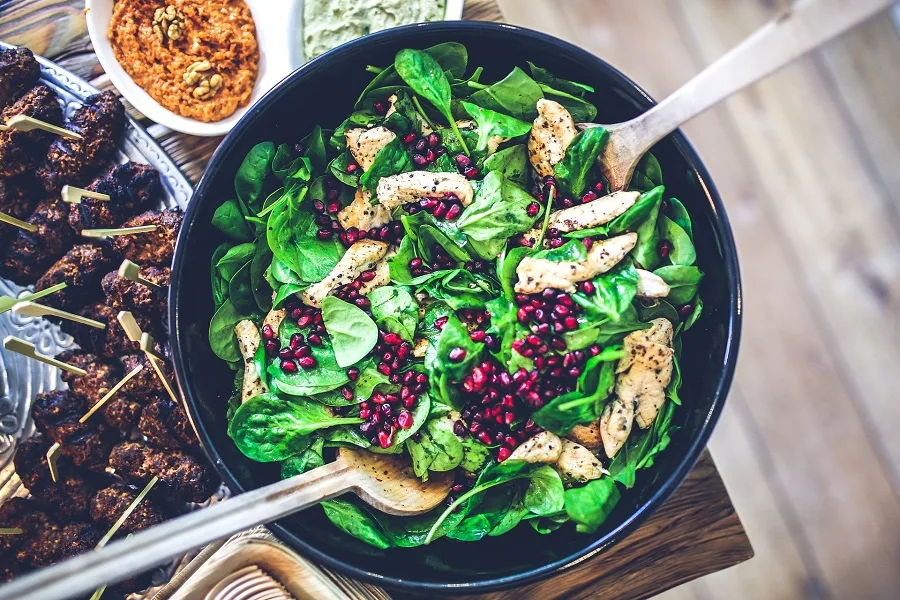 How to Cook Instant Pot Chicken Overhead View of a Bowl of Salad with Chicken Breast Mixed In