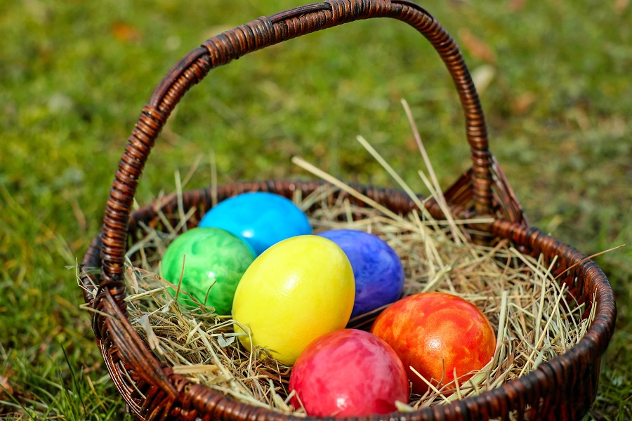  Instant Pot Easter Egg Recipes a Basket in Grass Filled with Easter Eggs in Different Colors