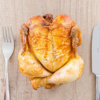 Instant Pot Whole30 Recipes with Chicken Overhead View of a Whole Roasted Chicken with a Fork and a Knife