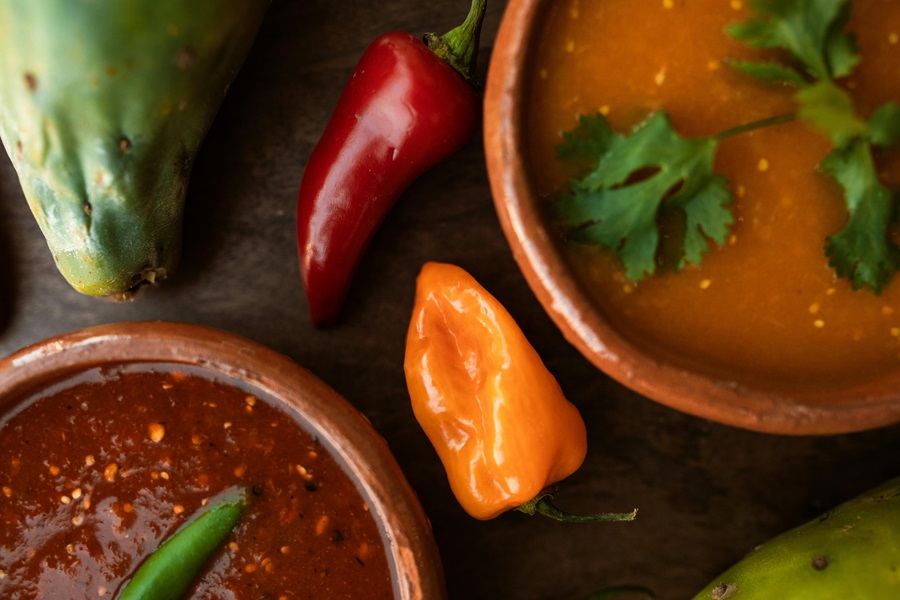 Crockpot Mexican Soup Recipes Close Up of Two Small Bowls of Soup Surrounded with Peppers